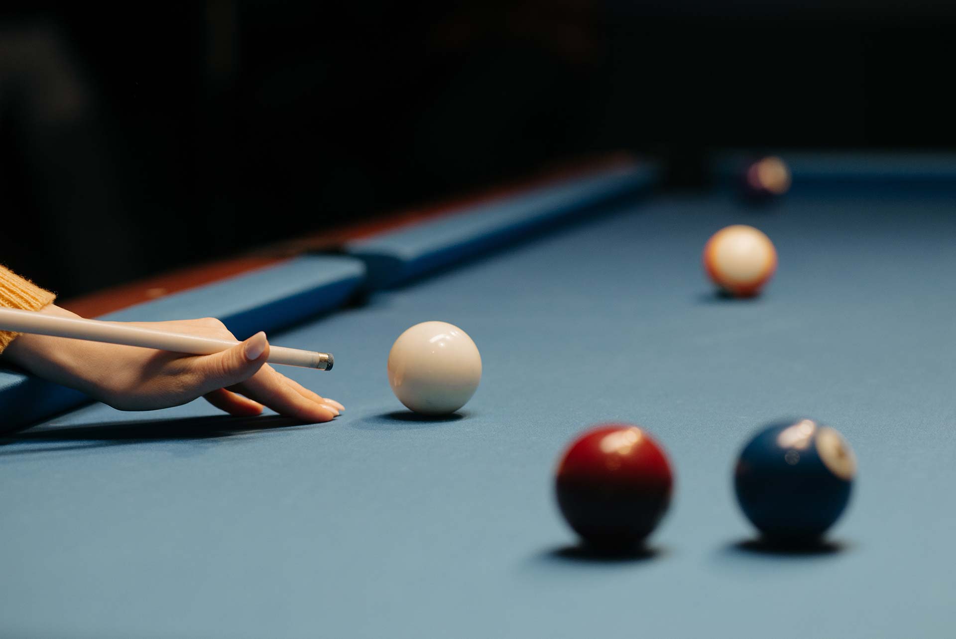 Pool cues, balls and chalk on a pool table